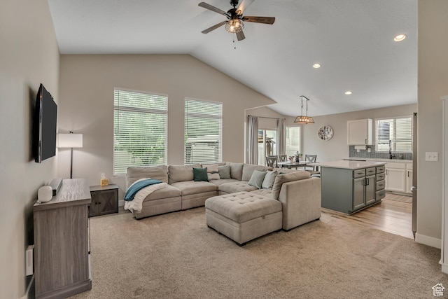 8831 W Digger Ln S, Magna, UT 84044 - living area with light colored carpet, ceiling fan, vaulted ceiling, and recessed lighting