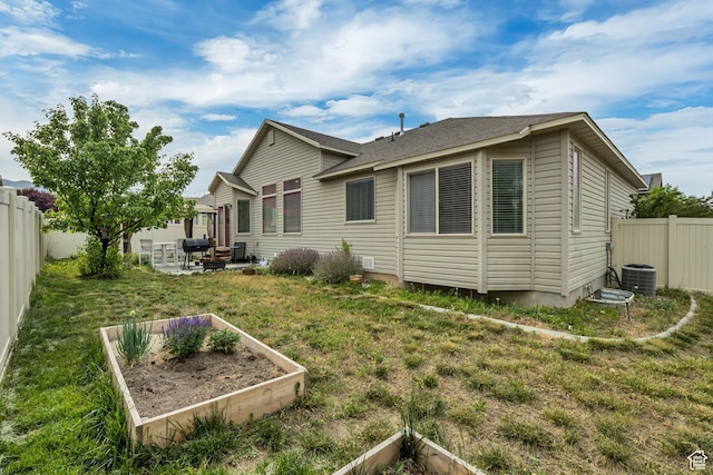 8831 W Digger Ln S, Magna, UT 84044 - rear view of property featuring a garden, a patio area, and cooling unit