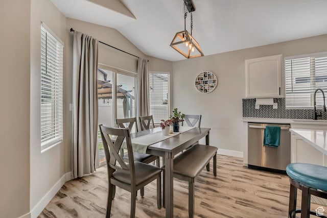 8831 W Digger Ln S, Magna, UT 84044 - dining space featuring vaulted ceiling, light wood-style flooring, and baseboards