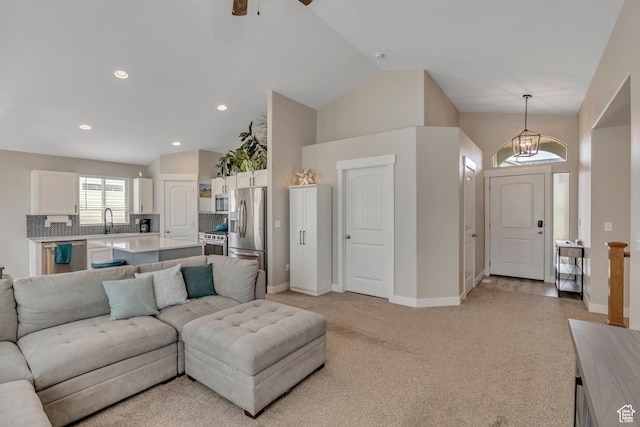 8831 W Digger Ln S, Magna, UT 84044 - living area with light carpet, baseboards, lofted ceiling, a ceiling fan, and recessed lighting