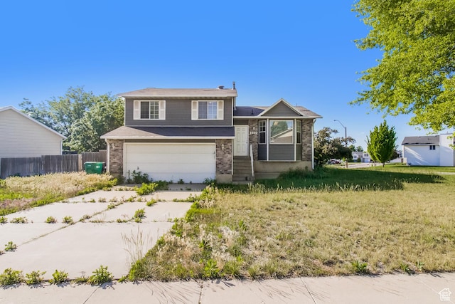 2802 W 4375 S, Roy, UT 84067 - tri-level home featuring a garage, brick siding, and concrete driveway