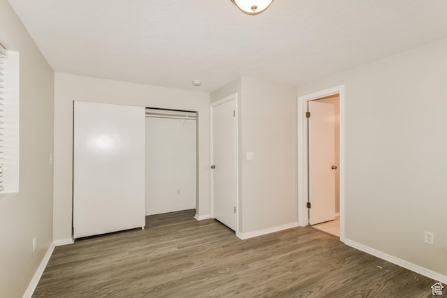 2802 W 4375 S, Roy, UT 84067 - unfurnished bedroom with wood finished floors, baseboards, and a closet