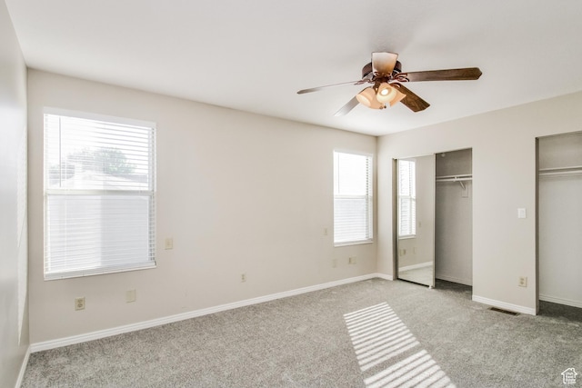 2802 W 4375 S, Roy, UT 84067 - unfurnished bedroom with multiple closets, light carpet, baseboards, and ceiling fan