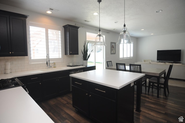 3639 S Clearwater Way, Syracuse, UT 84075 - kitchen with a sink, dark wood-style flooring, dark cabinets, backsplash, and light countertops