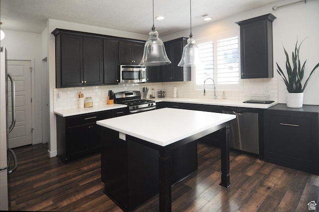 3639 S Clearwater Way, Syracuse, UT 84075 - kitchen featuring appliances with stainless steel finishes, a sink, dark wood-type flooring, decorative backsplash, and recessed lighting