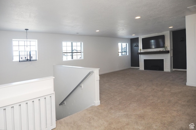 3639 S Clearwater Way, Syracuse, UT 84075 - unfurnished living room featuring light carpet, recessed lighting, a fireplace, baseboards, and a chandelier