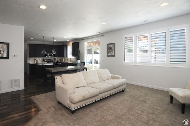 3639 S Clearwater Way, Syracuse, UT 84075 - living room featuring baseboards, recessed lighting, dark wood-style floors, and a textured ceiling