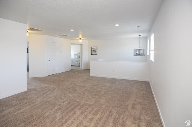 3639 S Clearwater Way, Syracuse, UT 84075 - spare room with light carpet, a chandelier, baseboards, and recessed lighting