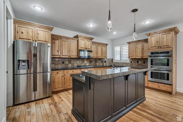1498 W Mule Train Dr, Bluffdale, UT 84065 - kitchen with stainless steel appliances, light wood-type flooring, dark countertops, a kitchen bar, and decorative backsplash