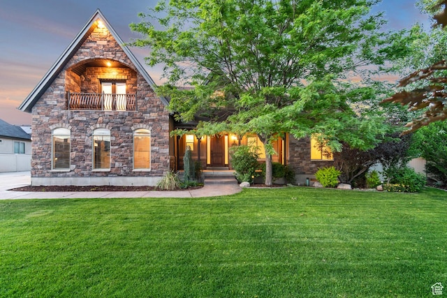 1498 W Mule Train Dr, Bluffdale, UT 84065 - view of front of house with a yard, stone siding, and a balcony