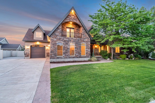 1498 W Mule Train Dr, Bluffdale, UT 84065 - view of front of home featuring stone siding, driveway, a balcony, and a garage