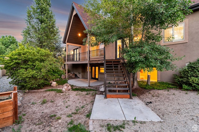1498 W Mule Train Dr, Bluffdale, UT 84065 - rear view of property featuring stairway, a patio area, a wooden deck, and stucco siding