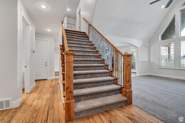 1498 W Mule Train Dr, Bluffdale, UT 84065 - staircase featuring arched walkways, hardwood / wood-style floors, baseboards, recessed lighting, and high vaulted ceiling