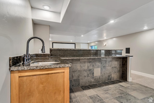 1498 W Mule Train Dr, Bluffdale, UT 84065 - kitchen featuring a sink, dark stone counters, baseboards, and recessed lighting