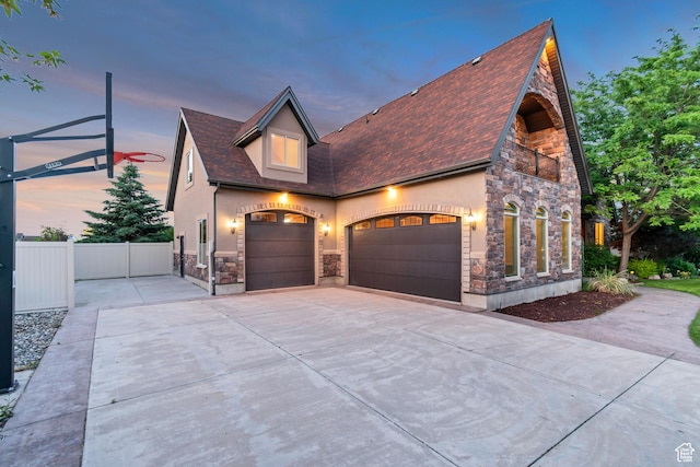1498 W Mule Train Dr, Bluffdale, UT 84065 - view of front of house with stone siding, driveway, and stucco siding