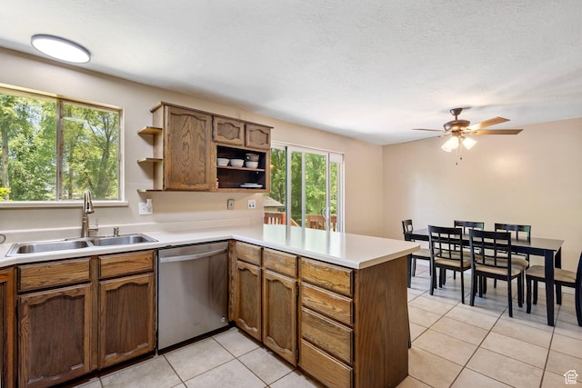 4070 W 2600 N, Corinne, UT 84307 - kitchen with stainless steel dishwasher, open shelves, a sink, a peninsula, and light tile patterned floors