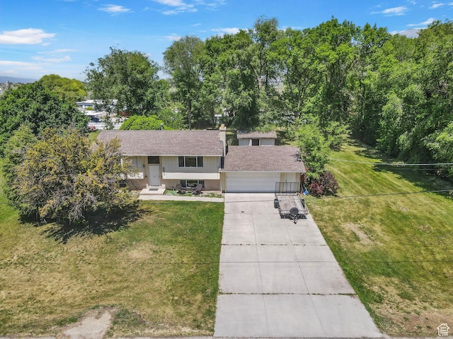 4070 W 2600 N, Corinne, UT 84307 - bi-level home with driveway, a shingled roof, a front yard, and brick siding