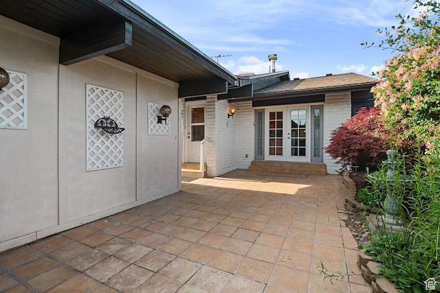 1047 E Eastgate Rd, Salt Lake City, UT 84117 - property entrance featuring french doors, brick siding, and a patio area