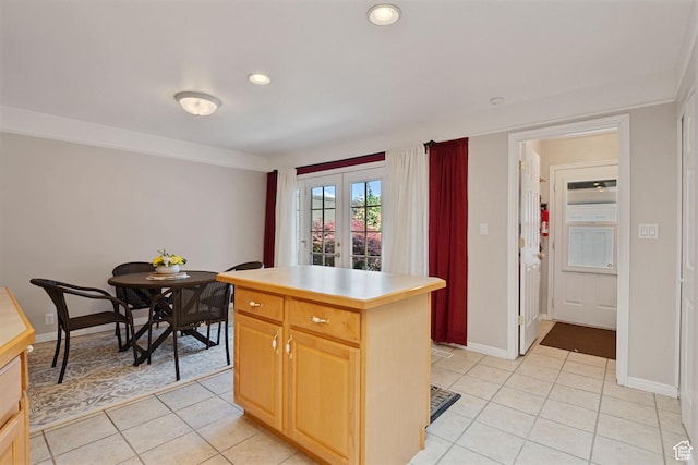 1047 E Eastgate Rd, Salt Lake City, UT 84117 - kitchen with light tile patterned flooring, light brown cabinets, a kitchen island, light countertops, and recessed lighting