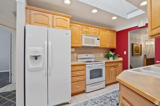 1047 E Eastgate Rd, Salt Lake City, UT 84117 - kitchen with white appliances, light tile patterned floors, a skylight, light countertops, and recessed lighting