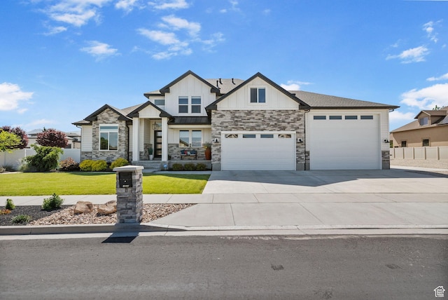 12612 S Starlite Hill Ln W, Herriman, UT 84096 - view of front of home featuring board and batten siding, an attached garage, driveway, and stone siding