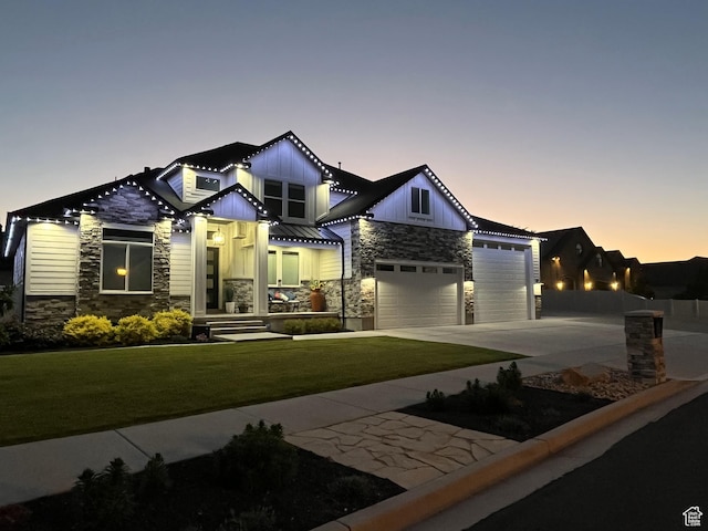12612 S Starlite Hill Ln W, Herriman, UT 84096 - view of front of house with stone siding, board and batten siding, concrete driveway, a garage, and a yard