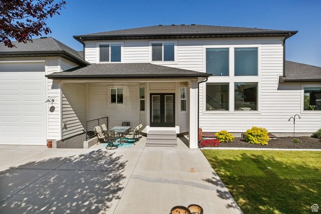12612 S Starlite Hill Ln W, Herriman, UT 84096 - view of front of home featuring french doors, a shingled roof, and a front lawn