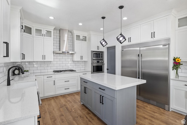 12612 S Starlite Hill Ln W, Herriman, UT 84096 - kitchen featuring built in appliances, wall chimney exhaust hood, gray cabinets, a sink, and white cabinets