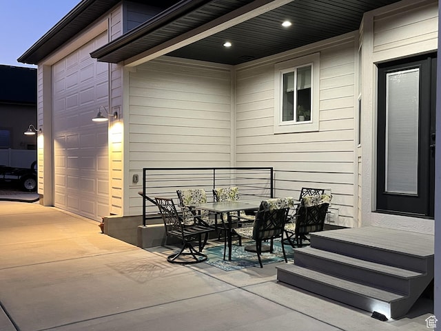 12612 S Starlite Hill Ln W, Herriman, UT 84096 - view of patio / terrace featuring a garage, outdoor dining area, and driveway