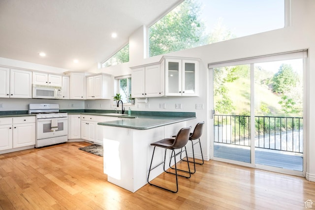 1559 E Oak Cliff Dr N, Provo, UT 84604 - kitchen featuring white appliances, a sink, high vaulted ceiling, a peninsula, and white cabinetry