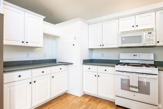 1559 E Oak Cliff Dr N, Provo, UT 84604 - kitchen with white appliances, dark countertops, light wood finished floors, and white cabinets
