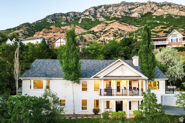 1559 E Oak Cliff Dr N, Provo, UT 84604 - rear view of property with a balcony, stucco siding, a mountain view, and a chimney