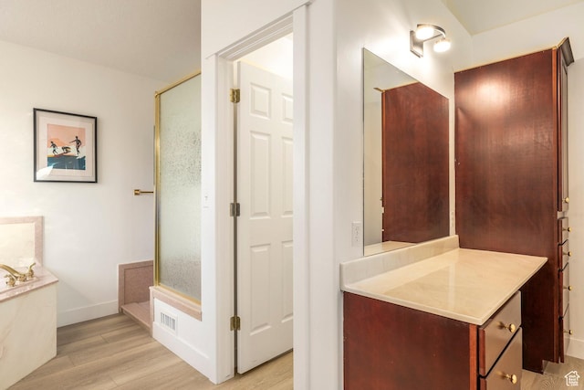 1559 E Oak Cliff Dr N, Provo, UT 84604 - bathroom with wood finished floors, vanity, a garden tub, baseboards, and a shower