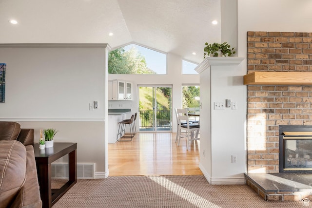 1559 E Oak Cliff Dr N, Provo, UT 84604 - carpeted living area featuring a brick fireplace, lofted ceiling, baseboards, recessed lighting, and wood finished floors