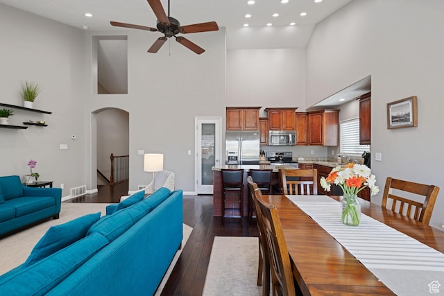 128 W 8600 S, Midvale, UT 84047 - dining space featuring a high ceiling, arched walkways, a ceiling fan, recessed lighting, and dark wood finished floors