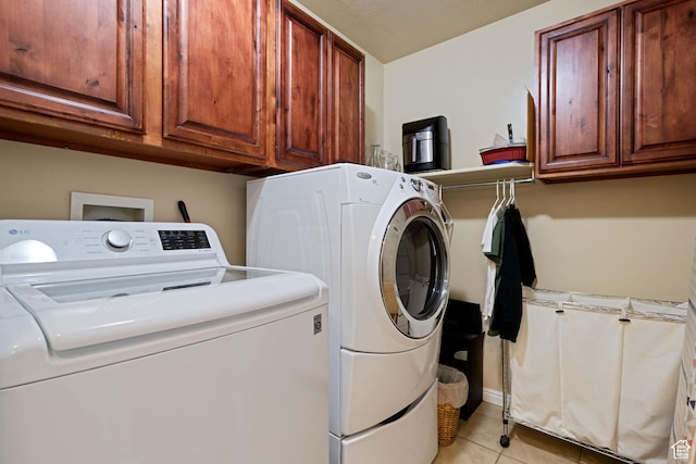 128 W 8600 S, Midvale, UT 84047 - laundry room featuring washer and clothes dryer, light tile patterned floors, and cabinet space