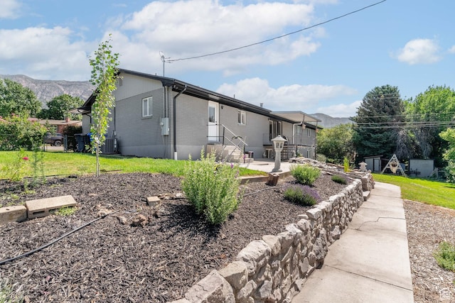 983 Westwood Dr, Pleasant View, UT 84414 - rear view of house with a patio area, central air condition unit, and a mountain view