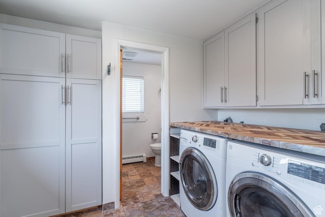 983 Westwood Dr, Pleasant View, UT 84414 - laundry room with washer and dryer, a baseboard heating unit, cabinet space, and stone finish flooring