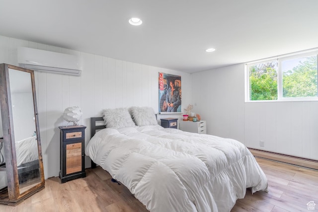 983 Westwood Dr, Pleasant View, UT 84414 - bedroom with a wall mounted air conditioner, baseboard heating, wood finished floors, and recessed lighting