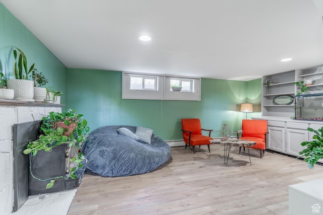 983 Westwood Dr, Pleasant View, UT 84414 - sitting room with light wood-type flooring, a baseboard radiator, a fireplace, and wooden walls