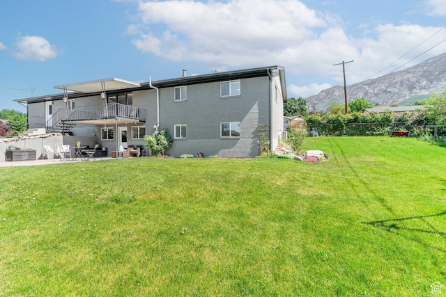 983 Westwood Dr, Pleasant View, UT 84414 - rear view of property featuring a patio area, a mountain view, stairway, and brick siding
