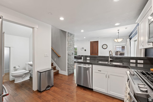 760 W Holliday Dr, Kamas, UT 84036 - kitchen featuring appliances with stainless steel finishes, a sink, white cabinetry, wood finished floors, and recessed lighting