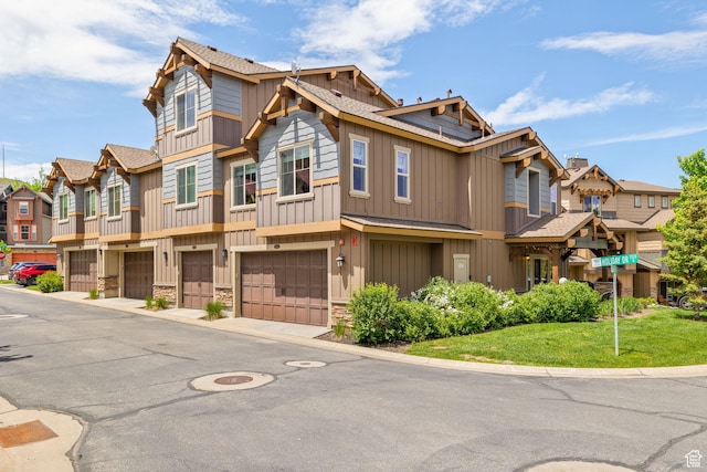 760 W Holliday Dr, Kamas, UT 84036 - view of front facade with an attached garage, a residential view, board and batten siding, stone siding, and driveway