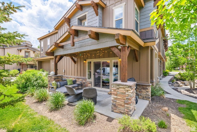 760 W Holliday Dr, Kamas, UT 84036 - rear view of house featuring board and batten siding, a patio area, an outdoor living space, and stone siding