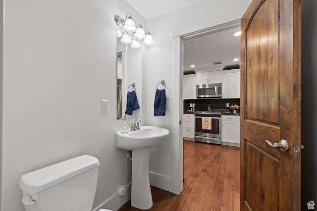 760 W Holliday Dr, Kamas, UT 84036 - bathroom with toilet, recessed lighting, wood finished floors, a sink, and baseboards