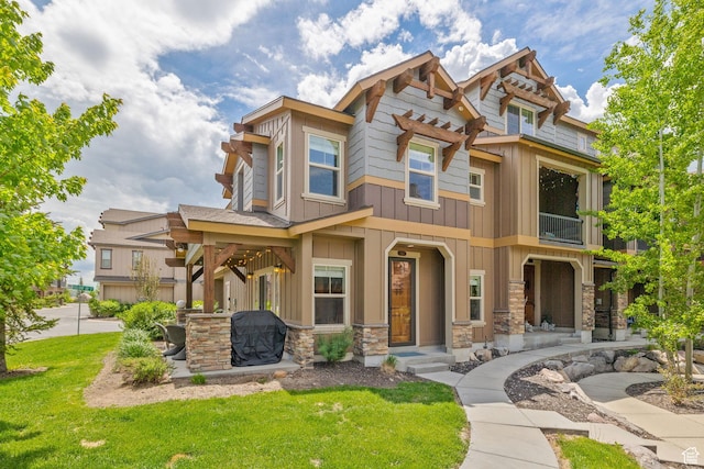 760 W Holliday Dr, Kamas, UT 84036 - view of front facade featuring a front lawn, stone siding, board and batten siding, and a balcony
