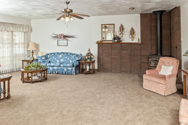 102 S 1000 W, Tremonton, UT 84337 - living room with a ceiling fan, a wood stove, carpet, and a textured ceiling