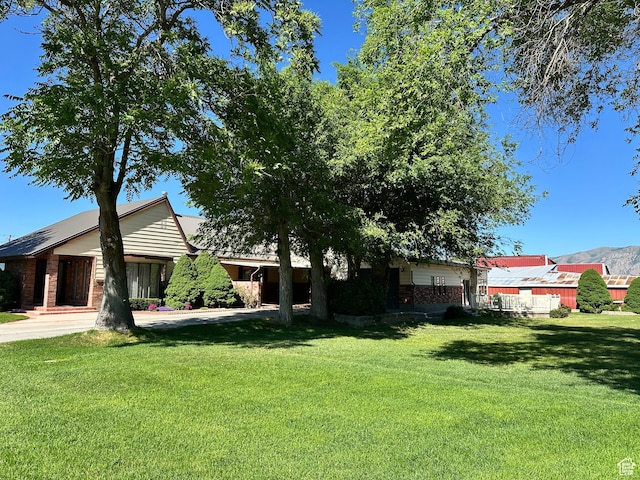 102 S 1000 W, Tremonton, UT 84337 - view of front facade with a front lawn and brick siding