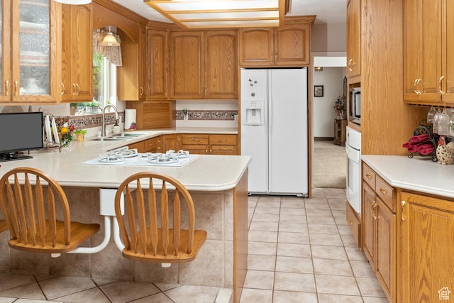 102 S 1000 W, Tremonton, UT 84337 - kitchen with white appliances, a sink, light countertops, a peninsula, and glass insert cabinets