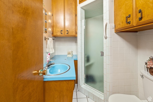 102 S 1000 W, Tremonton, UT 84337 - bathroom featuring toilet, a shower stall, vanity, tile patterned floors, and tile walls
